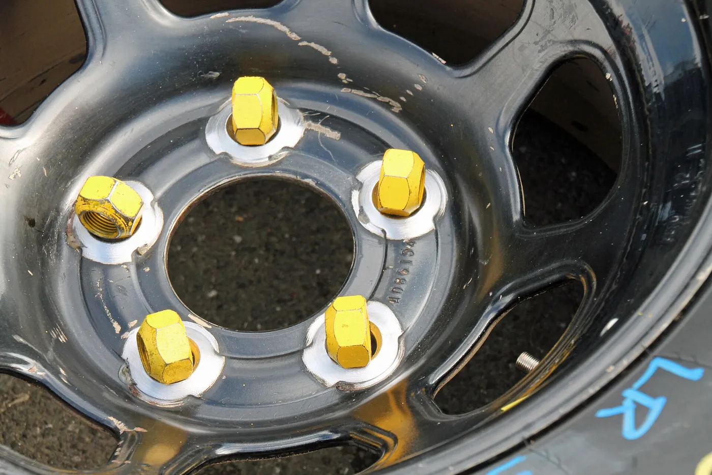 Lug nuts with seat washers on a steel wheel. The nut seat has to match the wheel, not just the thread.